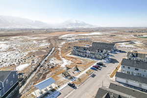 Snowy aerial view featuring a mountain view. Playground right outside front door.