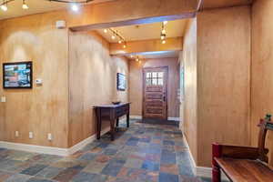 Foyer featuring wood walls