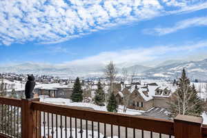 Snow covered deck featuring a mountain view