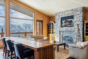 Living room with hardwood / wood-style flooring and a large fireplace