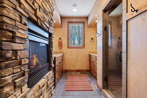 Bathroom featuring a shower with door and vanity