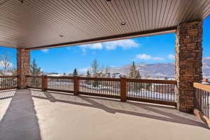 Snow covered patio featuring a mountain view