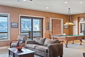 Game room with ceiling fan, billiards, a wealth of natural light, and carpet flooring