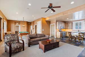 Living room featuring ceiling fan, pool table, and sink