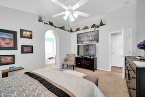 Carpeted bedroom with ceiling fan