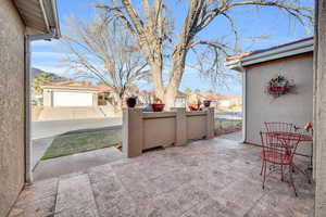 View of patio / terrace with a mountain view and a garage