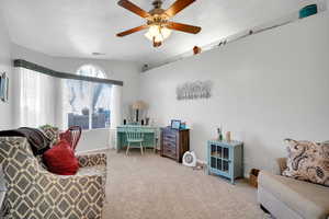 Office area with light carpet, vaulted ceiling, and ceiling fan