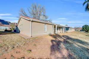 Back of house featuring a yard