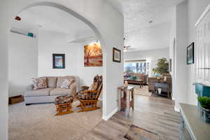 Living room featuring ceiling fan and light hardwood / wood-style flooring