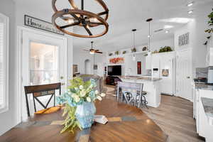 Dining room featuring light hardwood / wood-style floors, sink, ceiling fan, and a healthy amount of sunlight