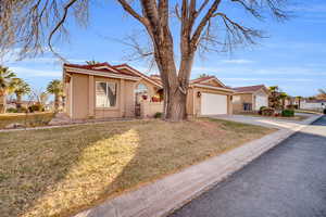 Ranch-style house with a front yard and a garage