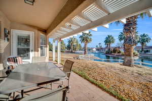 View of patio with a water view and a pergola