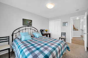 Carpeted bedroom with a closet