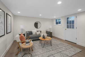 Basement Living room with light hardwood / wood-style flooring