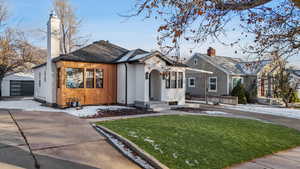 View of front of house featuring a front lawn and 2 car detached garage