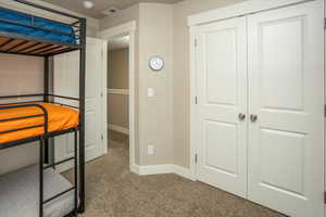 Unfurnished bedroom featuring a closet and carpet floors