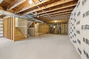 Unfinished basement featuring stairway