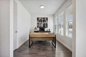 Office space featuring visible vents, baseboards, and dark wood-type flooring