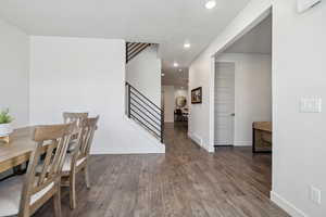 Dining space featuring recessed lighting, stairway, baseboards, and wood finished floors