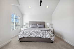 Carpeted bedroom with vaulted ceiling, ceiling fan, recessed lighting, and baseboards