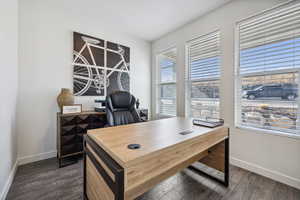 Office space featuring baseboards and dark wood-style flooring