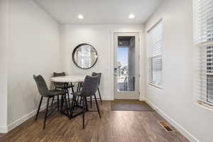 Dining area featuring hardwood / wood-style floors, recessed lighting, visible vents, and baseboards