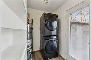 Washroom featuring stacked washer / drying machine and pantry