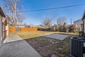 View of large yard with patio space for outdoor entertaining