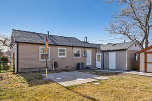 Rear view of property featuring a yard, a new roof, and a patio