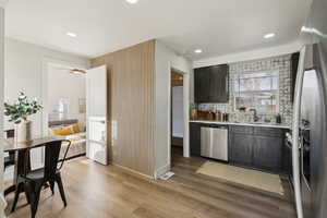 Kitchen featuring tasteful backsplash, appliances with stainless steel finishes, and LVP Flooring