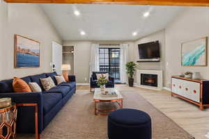 *Virtually Staged* Living room featuring light hardwood / wood-style floors and vaulted ceiling