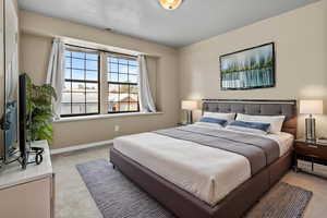 *Virtually Staged* Carpeted bedroom with a textured ceiling