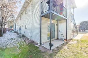 View of side of home with enterance to attached storage shed