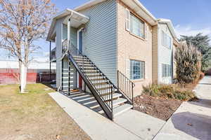 View of side of property featuring a lawn