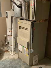 Utilities featuring heating unit and gas water heater