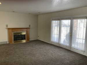 Large living room with Fireplace and Access to Covered Patio