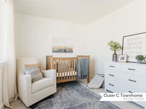 Bedroom with carpet and a crib