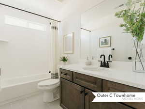 Full bathroom with toilet, tile patterned floors, vanity, and shower / bath combo