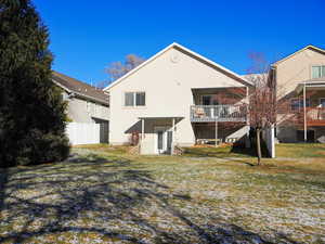 Rear view of house open yard and a deck