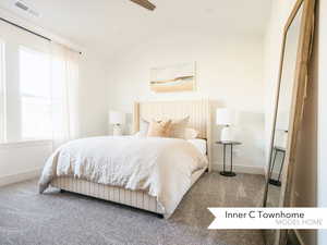 Bedroom with ceiling fan, carpet, and lofted ceiling