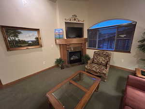 Living room featuring carpet and a fireplace
