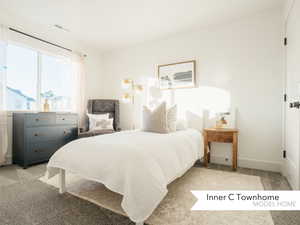 Bedroom with light colored carpet