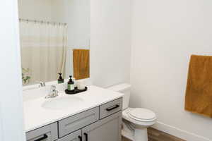 Bathroom with LVP flooring, toilet, and vanity