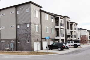 View of building exterior with a detached garage