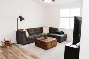 Living room with LVP flooring and ceiling fan