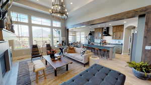 Living room with a mountain view, sink, a chandelier, and light hardwood / wood-style floors