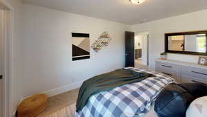 Bedroom featuring light colored carpet