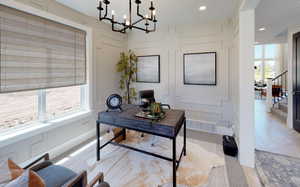 Office featuring a healthy amount of sunlight and a chandelier