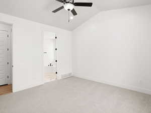 Unfurnished room featuring lofted ceiling, light colored carpet, and ceiling fan