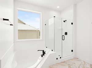 Bathroom featuring shower with separate bathtub